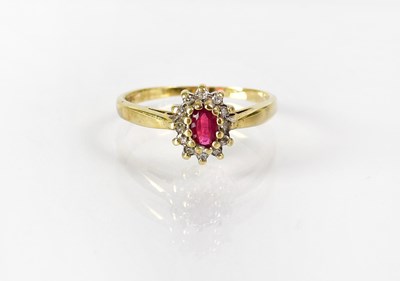 Lot 826 - A 9ct gold cluster ring set with central ruby...