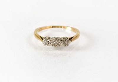 Lot 823 - A 9ct gold ring set with three small diamonds...