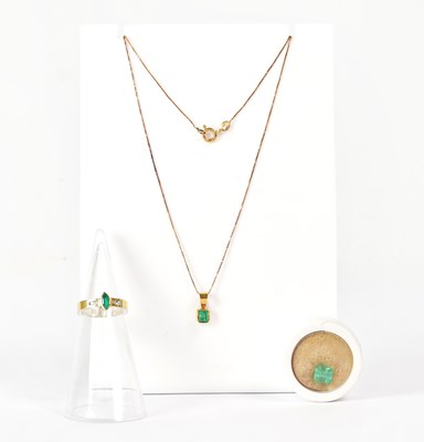 Lot 851 - An 18ct gold pendant set with an emerald,...