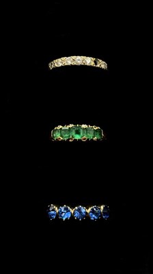 Lot 1253 - A yellow metal and emerald five stone ring,...
