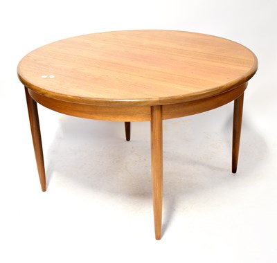 Lot 11 - G-PLAN; a teak circular extending dining table,...