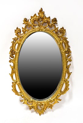 Lot 127 - A gilt framed oval mirror, height 97cm.
