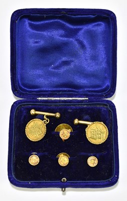 Lot 1519 - A pair of yellow metal cufflinks set with...