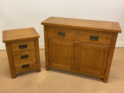 Lot 667 - An oak chest with two drawers above a cupboard,...