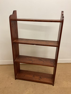 Lot 672 - A stained pine open bookcase with three...