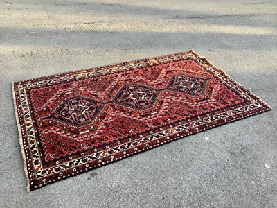 Lot 1321 - A hand knotted wool red ground Kashgai...