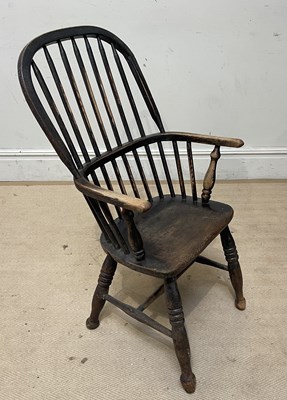 Lot 1047 - A 19th century elm seated Windsor elbow chair,...