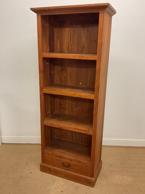 Lot 674 - A stained pine open bookcase with three...