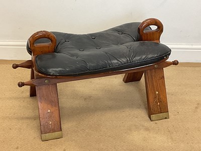 Lot 676 - A wooden camel seat with a black leather...