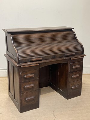 Lot 1209 - A 1920s oak roll top desk, the tambour...