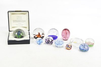 Lot 819 - A group of glass paperweights including...