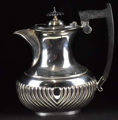 Lot 868 - A George V hallmarked silver teapot with ebony...