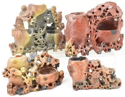 Lot 654 - Four carved hardstone figures, many with vases,...