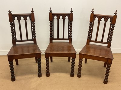 Lot 601 - Three 19th century Gothic oak hall chairs. H...