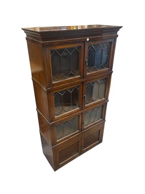 Lot 1155 - SIMPOLES, CHAPTER FURNITURE; an oak four tier...
