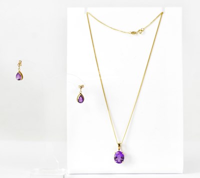 Lot 1103 - A 9ct yellow gold pendant set with an oval...