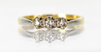 Lot 1028 - An 18ct yellow gold ring set with three...