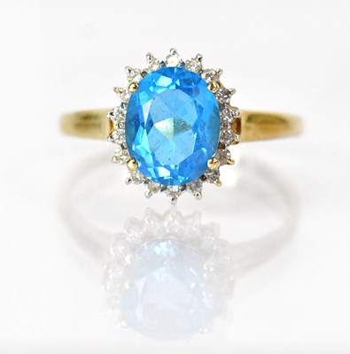 Lot 1043 - A 9ct yellow gold ring set with a blue stone,...