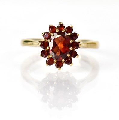 Lot 1046 - A 9ct yellow gold ring set with a central...