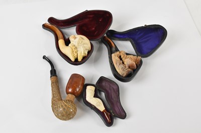Lot 1431 - A collection of four pipes comprising a carved...