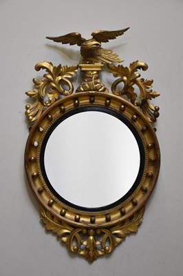 Lot 1013 - A Regency gilt framed convex wall mirror, with...