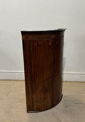 Lot 1279 - A Georgian inlaid mahogany bowfronted hanging...
