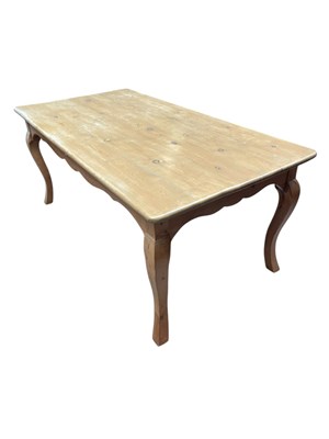 Lot 1039 - A pine refectory dining table on cabriole legs,...