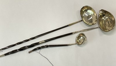 Lot 1068 - Three 19th century silver toddy ladles, with...