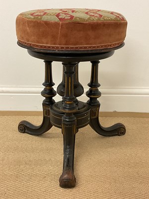 Lot 638 - An ebonised Aesthetic Movement adjustable...