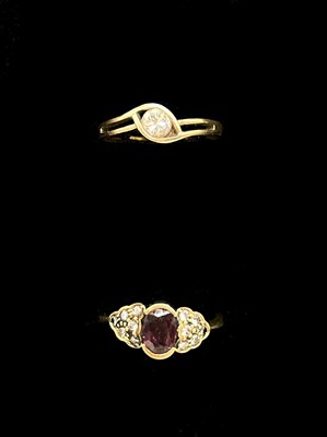 Lot 1136 - Two yellow metal rings, one set with diamond...