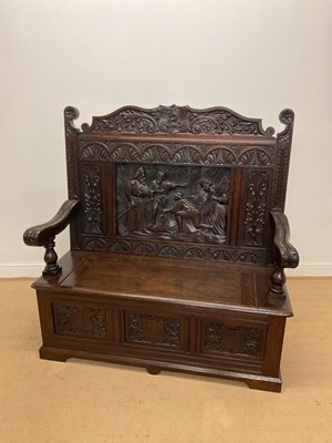 Lot 595 - A carved oak settle, height 127cm, width 127cm,...