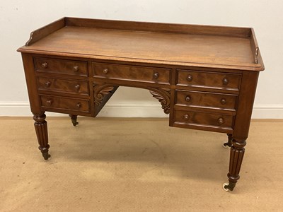 Lot 605 - A seven drawer mahogany desk, height 80cm,...