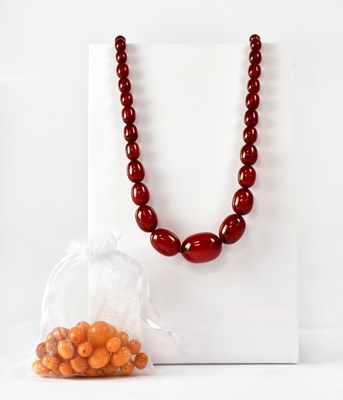 Lot 1090 - A cherry amber style graduated bead necklace,...