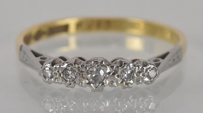 Lot 1129 - An 18ct yellow gold and platinum diamond set...