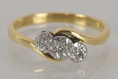 Lot 1142 - An 18ct yellow gold three stone diamond set...