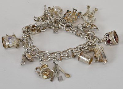 Lot 1312 - A 925 hallmarked silver charm bracelet, with...