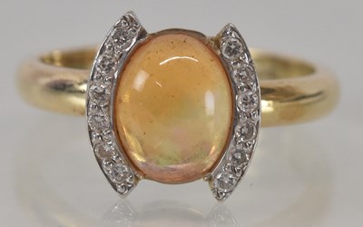 Lot 1168 - A 9ct yellow gold diamond and cabochon topaz...