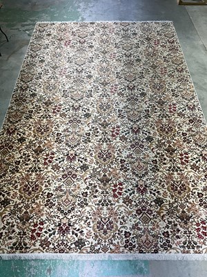 Lot 552 - A large Persian rug with cream background...