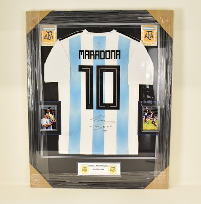 Lot 1453 - DIEGO MARADONA; a framed display featuring a...