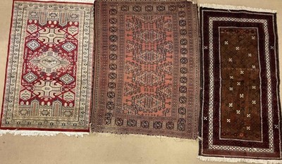 Lot 556 - A vintage Persian style rug with two others,...