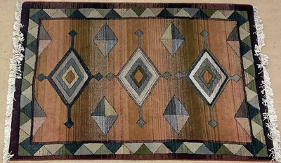 Lot 557 - A machine woven rug, decorated with diamond...
