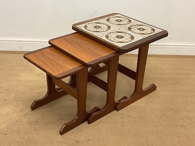 Lot 631 - G PLAN; a nest of three teak tables, the...