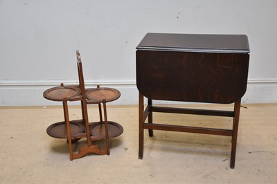Lot 1285 - A carved mahogany two tier folding cake stand...