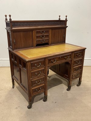 Lot 1133 - An Edwardian carved mahogany kneehole desk,...