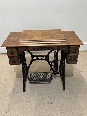 Lot 1317 - SINGER; a treadle sewing machine with cast...