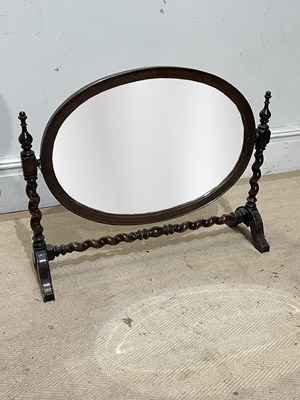 Lot 1286 - A 1920s oak oval swing toilet mirror, on...
