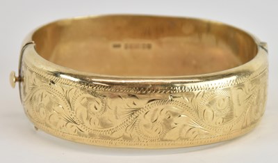 Lot 1304 - A 9ct gold hinged bracelet with snap clasp,...