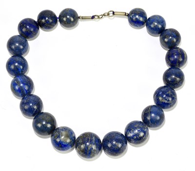 Lot 1400 - A lapis lazuli beaded necklace, with white...