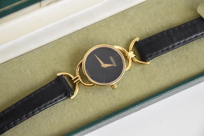 Lot 602 - GUCCI; a lady's gold plated wristwatch, with...