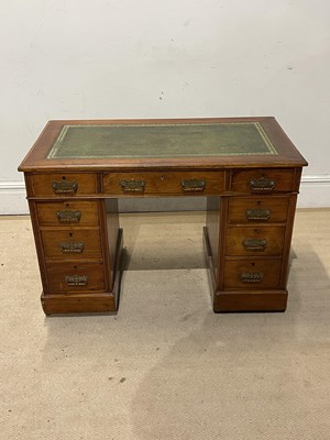 Lot 1151 - An Edwardian knee-hole desk with green leather...